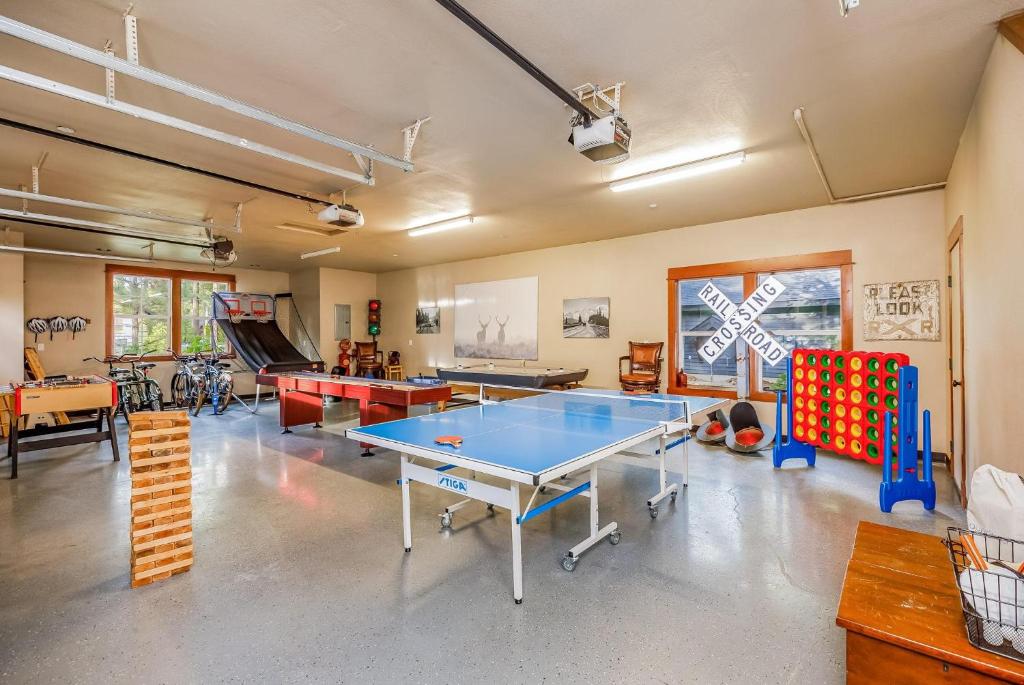 a large room with a ping pong table and other games at 7th Heaven in Cle Elum
