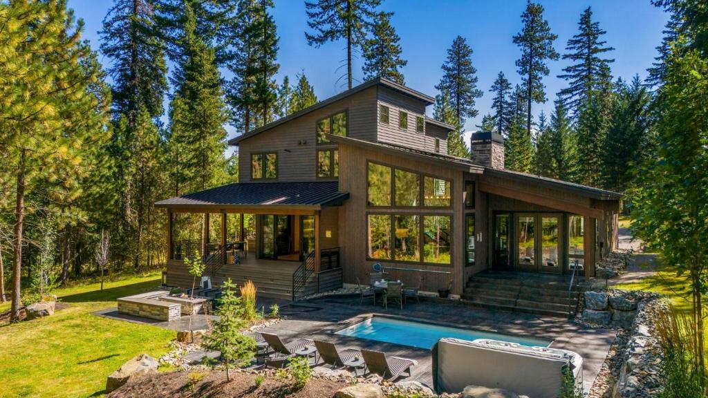 a house with a pool in front of it at Whispering Woodland in Cle Elum