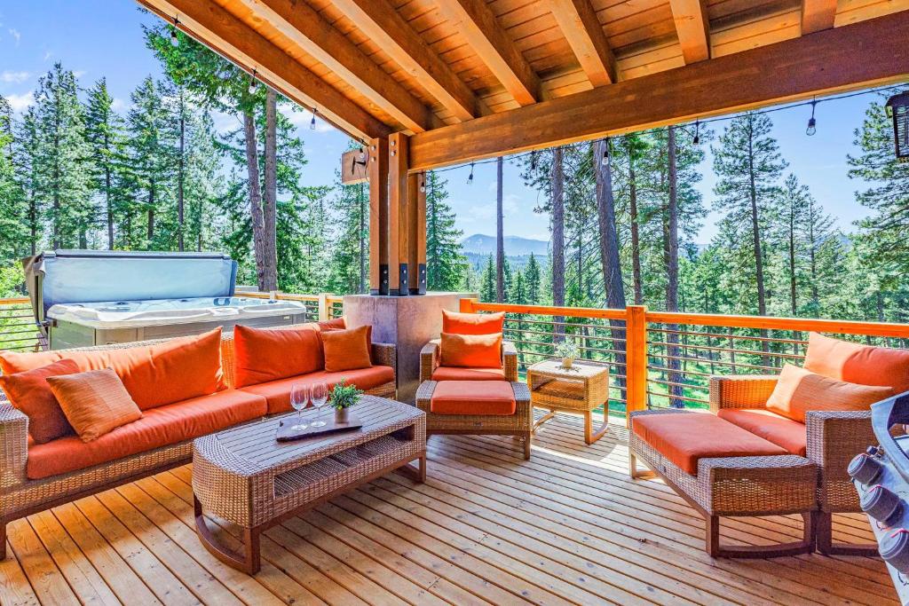 a porch with a couch and chairs on a deck at Three Pines in Cle Elum