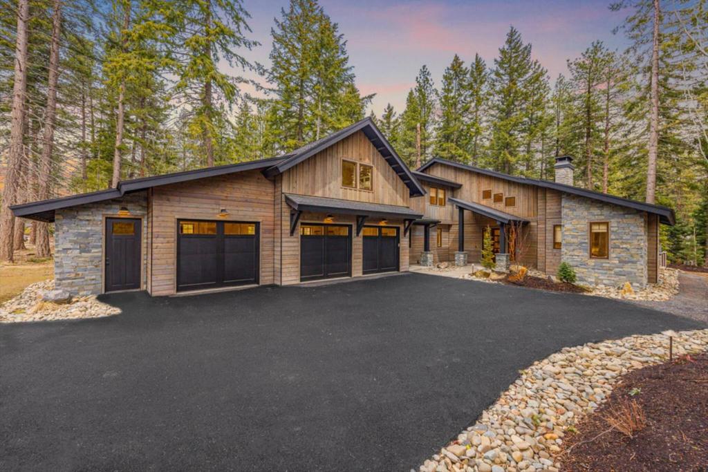 a house with a garage in the woods at Mountain Modern Lodge in Cle Elum