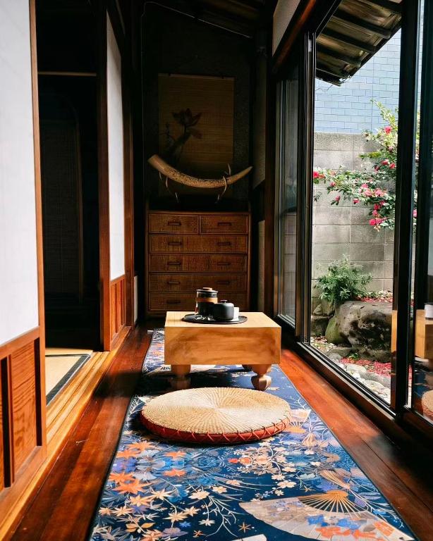a living room with a table and a rug at 海の風-春 in Wakayama