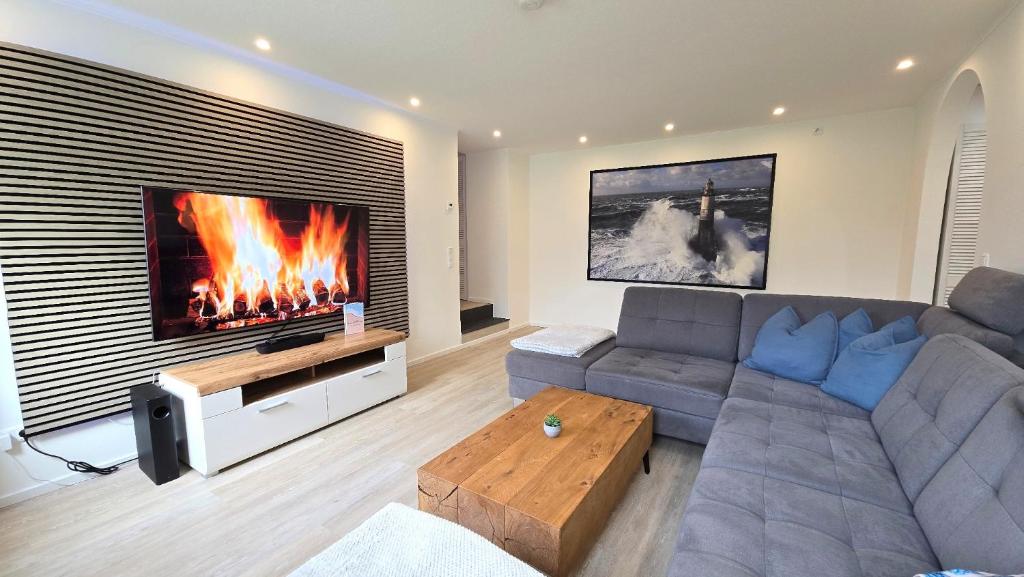 a living room with a couch and a fireplace at Ferienwohnung "Ostseebrise" in Wendtorf in Wendtorf