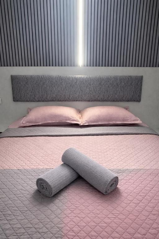 a pink bed with a headboard and a pink bed frame at My house in Constanţa