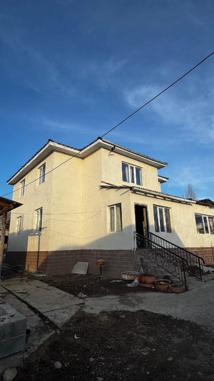 a large white house with at East guest house in Tegermenti