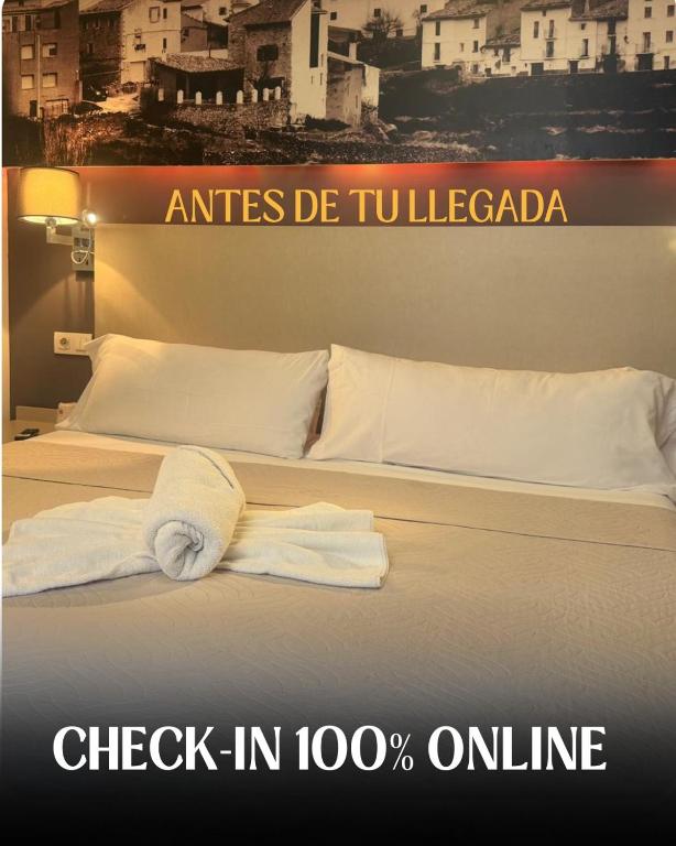 a hotel room with a bed with a towel on it at Hello Villarreal - Sant Joan in Villareal
