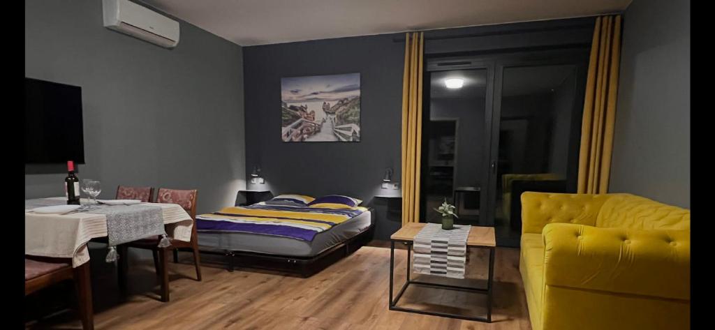 a room with a bed and a table and a couch at Stacja Nałęczów 1 in Nałęczów
