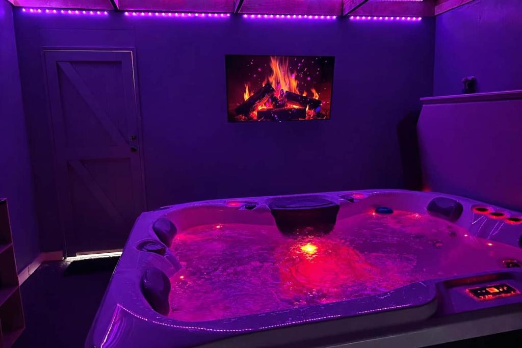 a room with a hot tub with a fire in it at Romantic getaway with private hot tub in Belfast