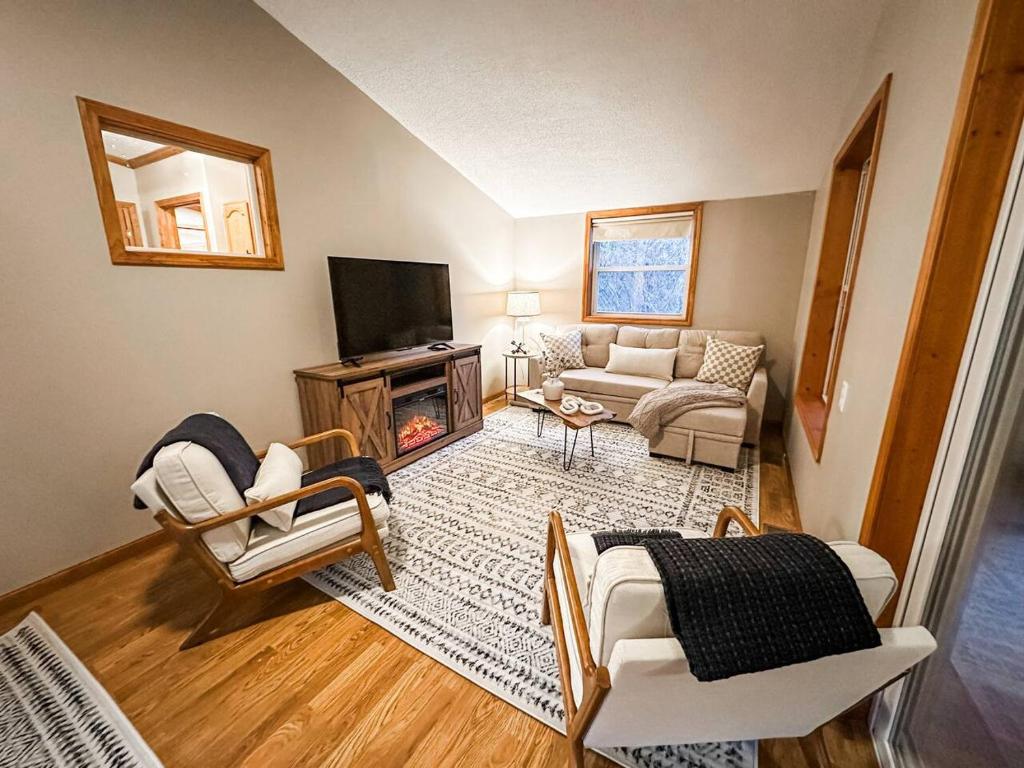 a living room with a couch and a fireplace at Blue Ribbon Cabin in Farwell