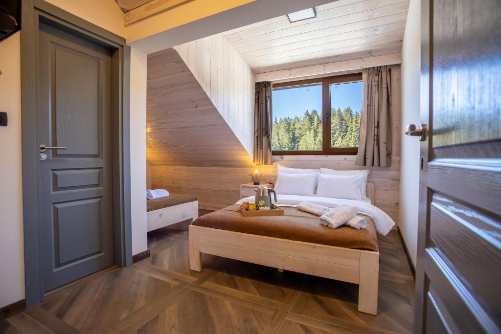 a bedroom with a bed and a window at River Bridge in Žabljak