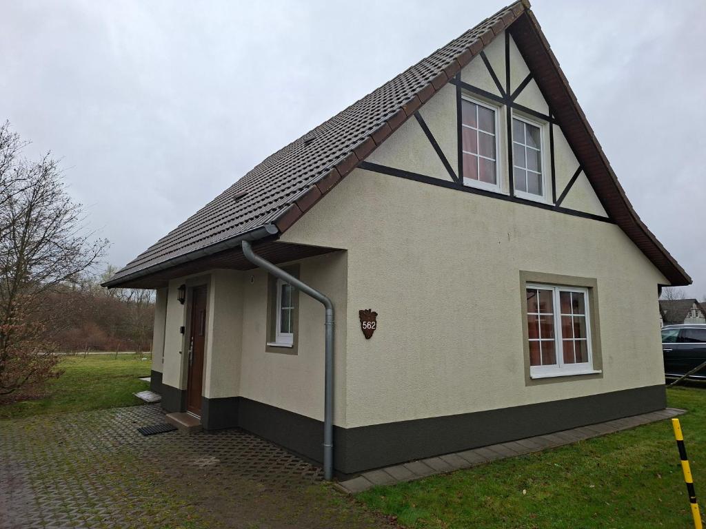 a small white house with a gambrel roof at Haus am Golfplatz Cochem Mosel in Ediger-Eller