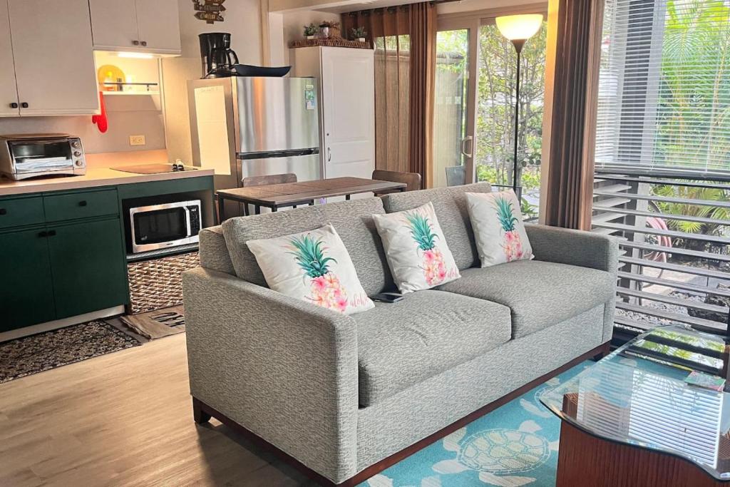 a living room with a couch and a kitchen at 43 Studio Queen Bed in Pahala