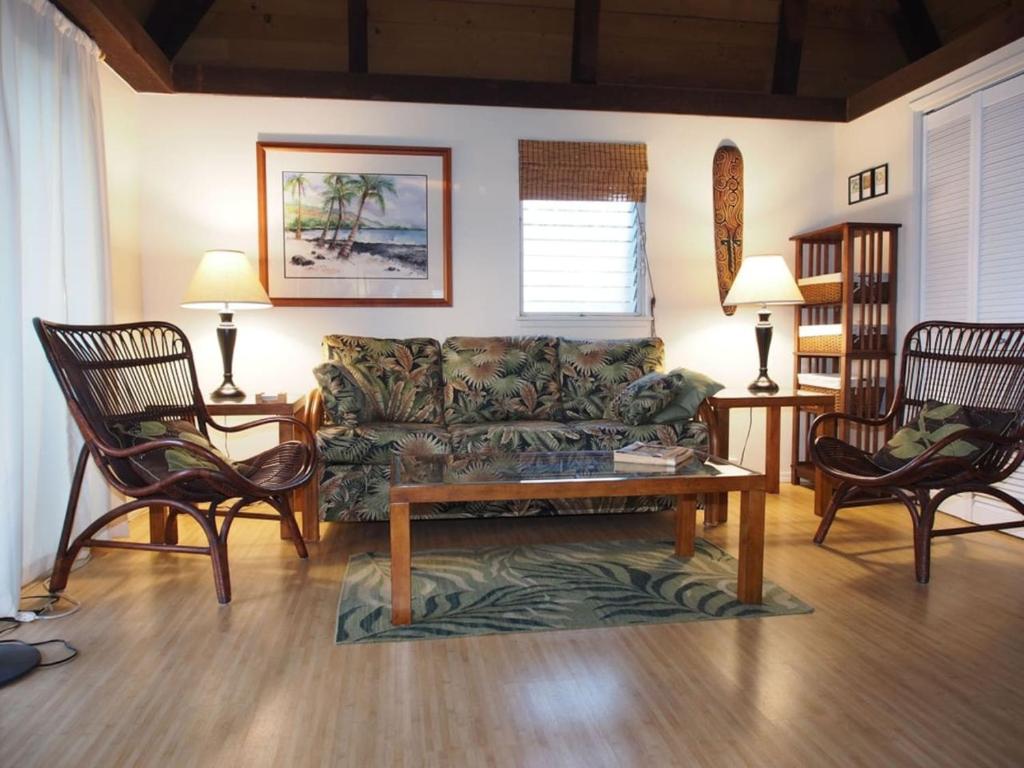 a living room with a couch and two chairs at 54 Old Hawaii Charm Condo in Pahala