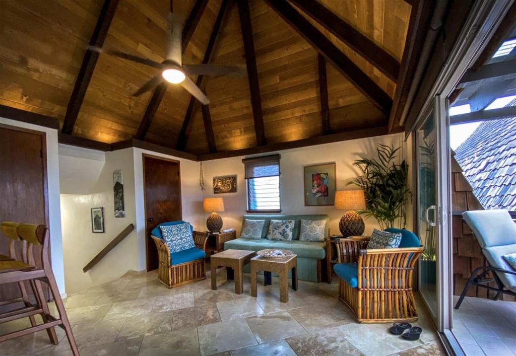 a living room with a couch and chairs at 70 Pogs Place at Black Sand Beach in Pahala