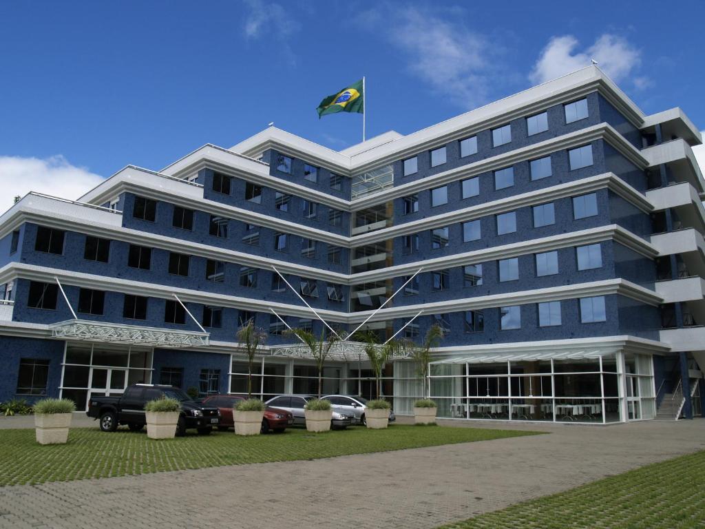 a large blue building with a kite on top of it at Locanda Hotel in Novo Hamburgo