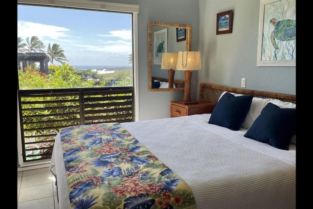 a bedroom with a bed and a large window at Unit 05 Well Maintained Studio in Pahala