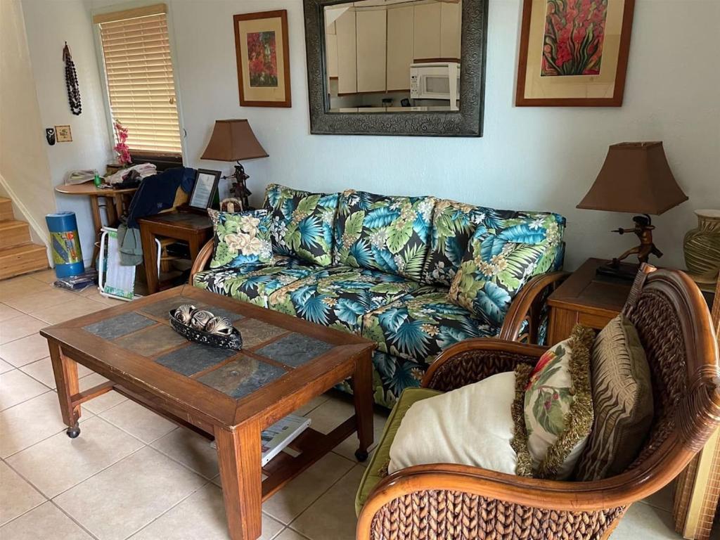 a living room with a couch and a coffee table at Unit 25 Hula Hut Best Value in Pahala