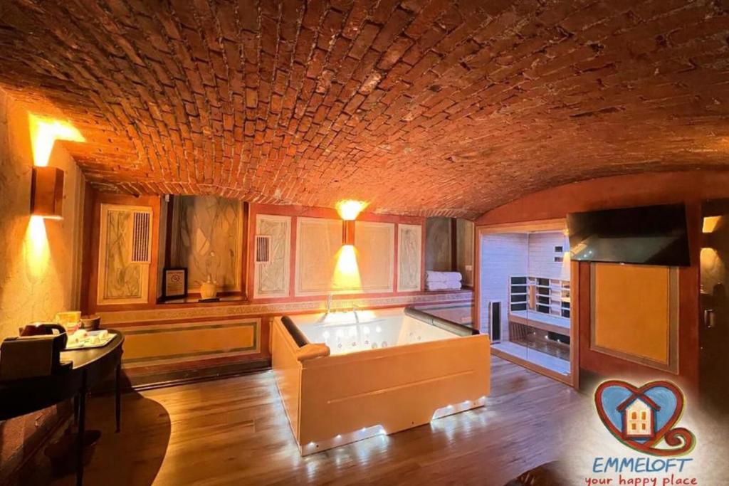 a living room with a couch and a table at Emme Loft I Sweet Moon - Exclusive Loft & Private Spa Milan in Milan