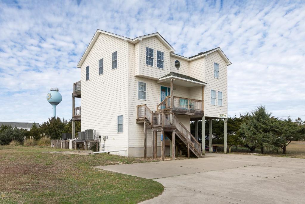 a large white house with a water tower at 7030 - Waves Against the Machine in Rodanthe