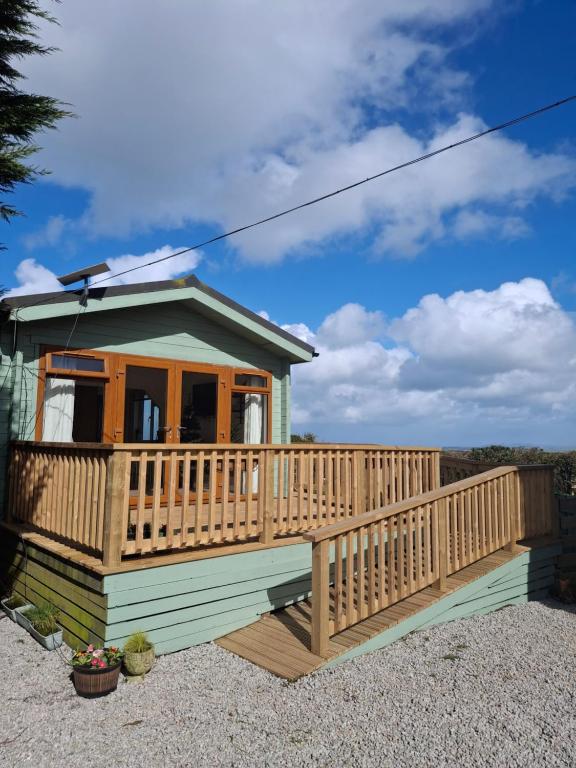 a small house with a deck on a hill at The Cabin in Carbis Bay