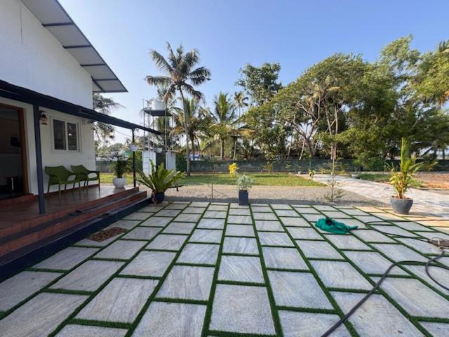 a porch of a house with a patio with plants at River Breeze Cherai in Cochin