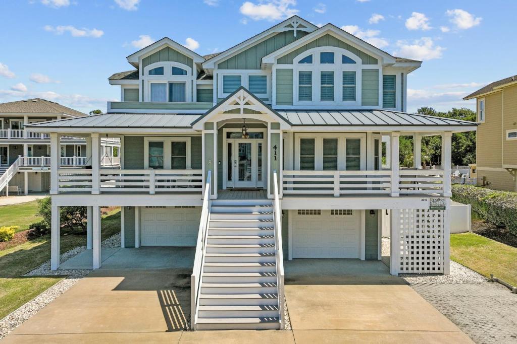 a house with a porch and a garage at 4919 - The Leonardo in Kitty Hawk