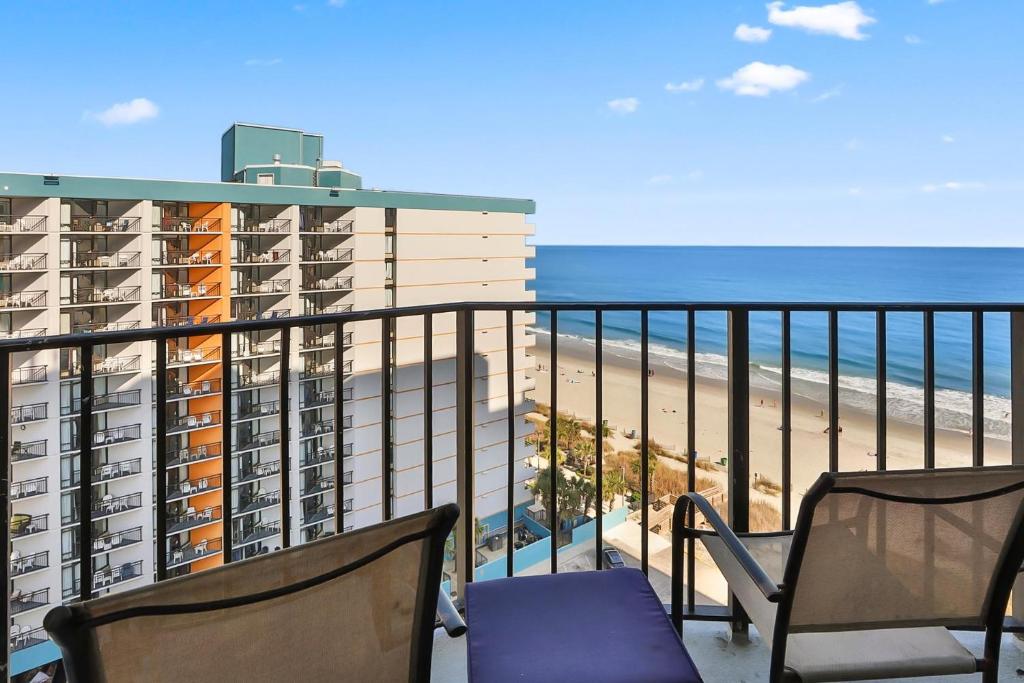 a balcony with two chairs and the beach at The Palace Resort #1114 in Myrtle Beach