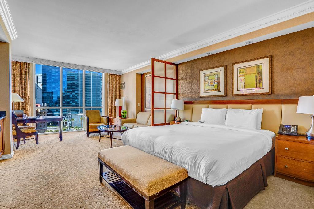 a hotel room with a large bed and a desk at MGM Signature Tower 2 8th Floor 2-Suite Strip View Balcony No Resort Fee in Las Vegas