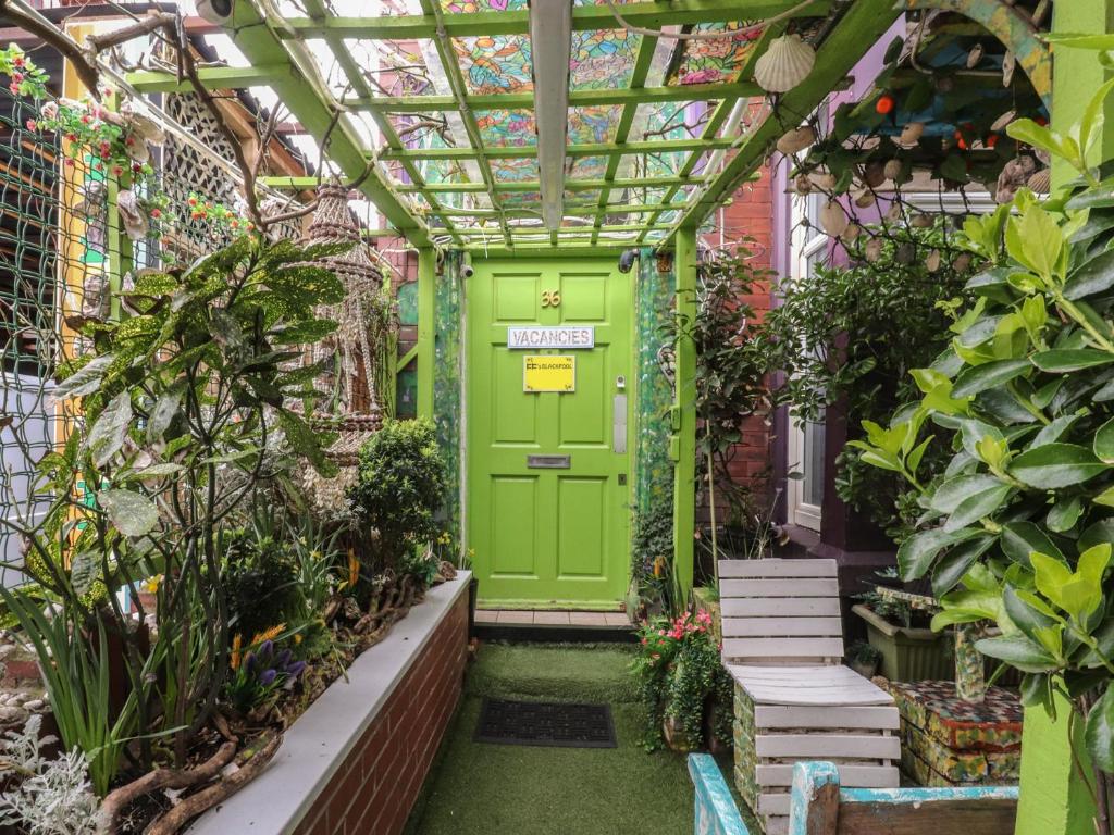 a green door in a greenhouse with plants at Number 3 in Blackpool
