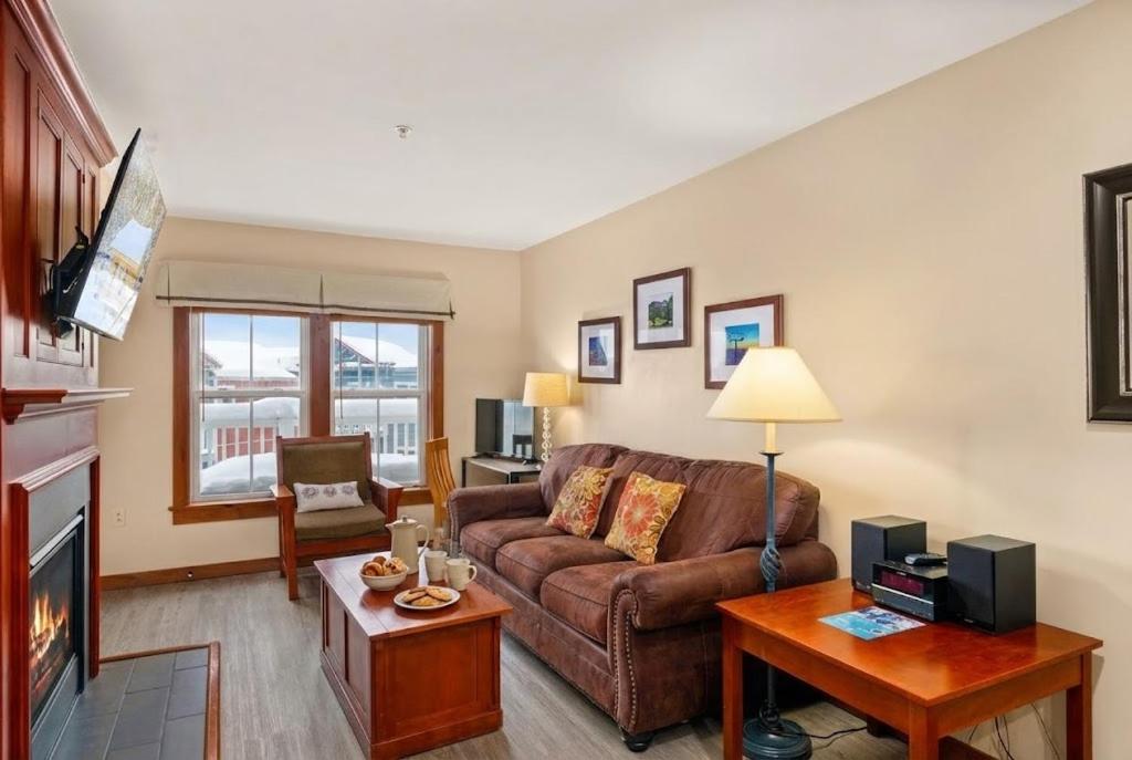 a living room with a couch and a table at AS 326 No Resort Fee Pool-View Ski-InOut in Snowshoe