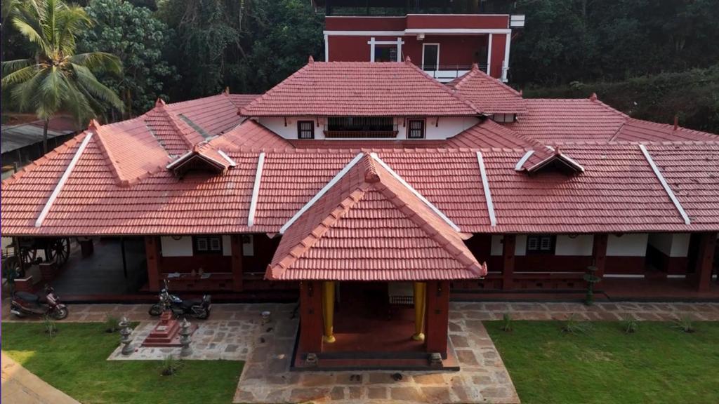 a house with a red roof at Srikadhama in Udupi