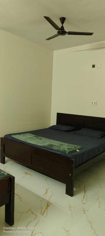 a bed in a room with a ceiling fan at Srinivasa Hotel in Narasingāpuram