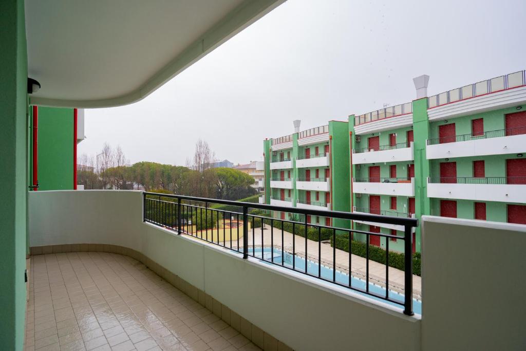 a balcony with a view of a building at Residence Roberta - Agenzia Arcobaleno in Caorle