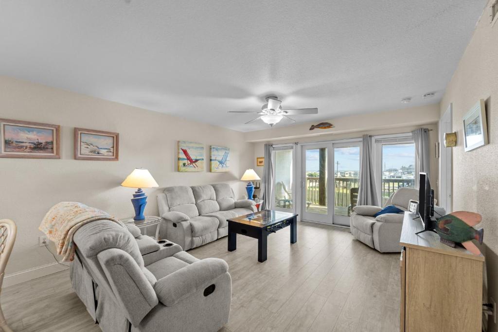a living room with two couches and a tv at 7081 - Sea View in Rodanthe