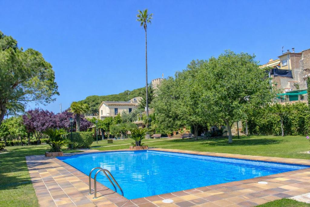 a swimming pool in a yard with trees at Catalunya Casas Unique sanctuary with extra large pool! in Santa Oliva