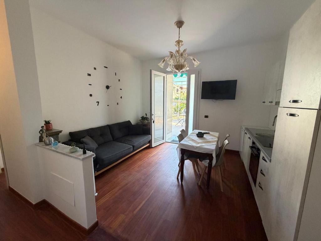 a living room with a couch and a table at Arma central Garden in Arma di Taggia