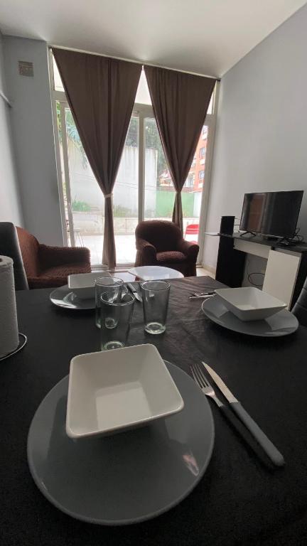 a table with a white plate on top of it at PB-Súper dpto Morón centro in Morón