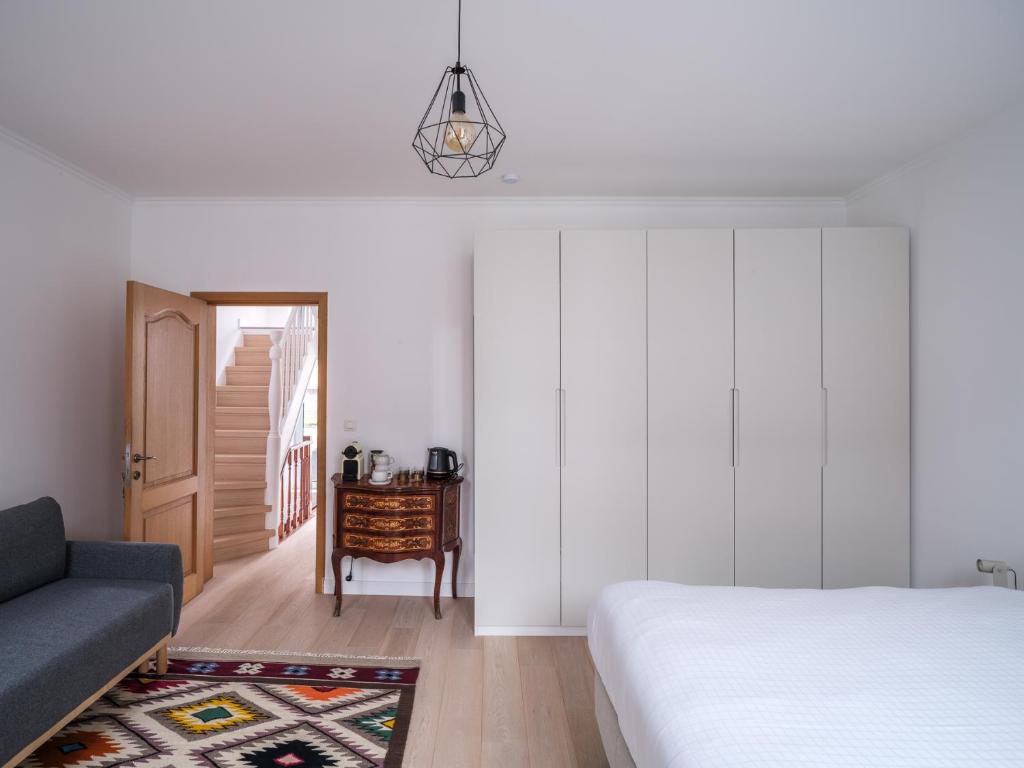 a bedroom with a bed and a couch and a table at Suzan's Guesthouse in Ghent