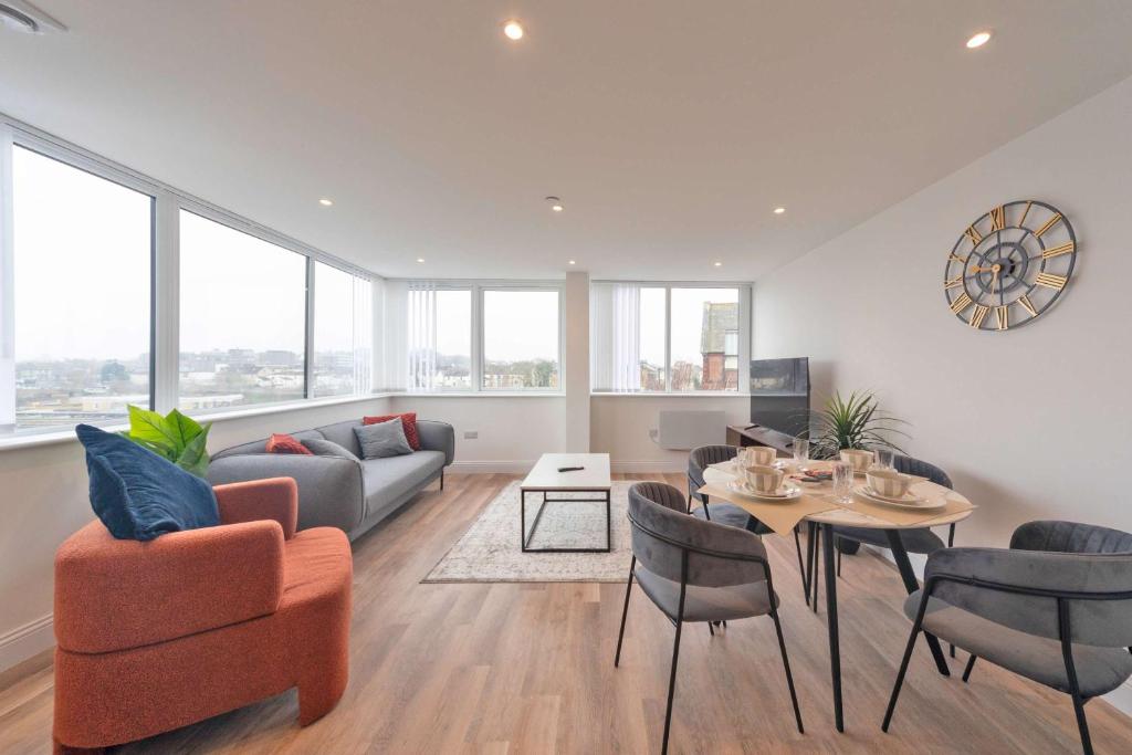 a living room with a couch and a table at Bright 2BR Apartment at Trinity Point in Gravesend