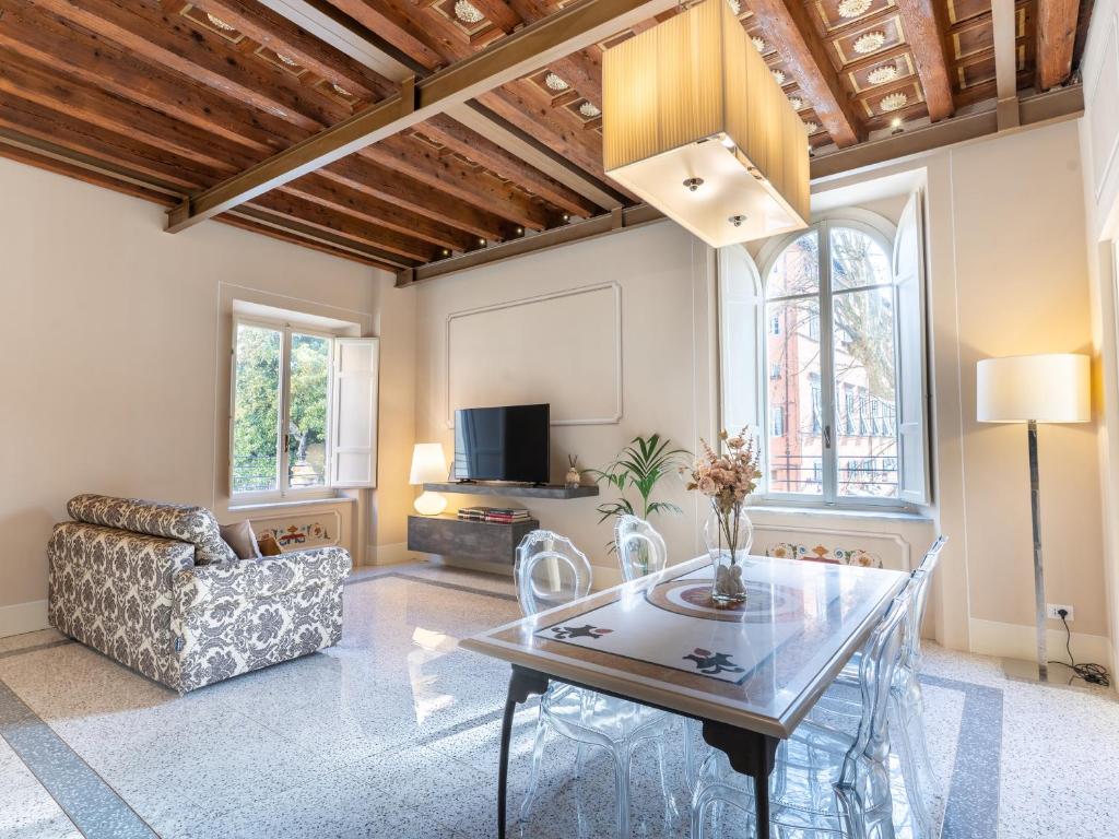 a living room with a table and a couch at Noble Floor - Panoramic Luxury Apartment in Lucca