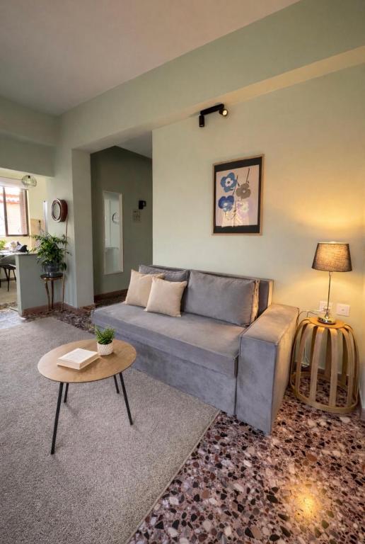 a living room with a couch and a table at The Citrus Yard in Politika, 2 bedrooms apartment in Politika