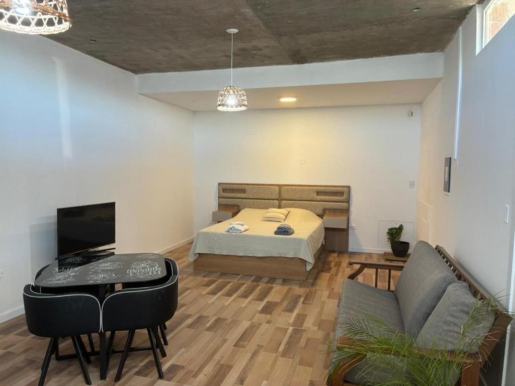 a bedroom with a bed and a desk and a couch at Rincón del Agreste in Neuquén