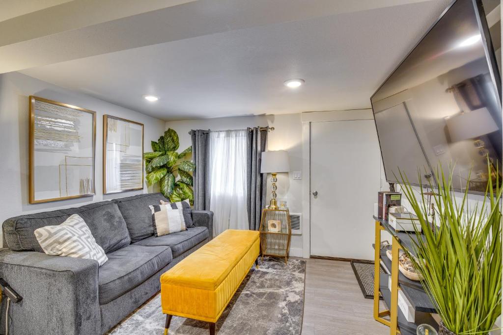 a living room with a couch and a table at Work & Explore Downtown Tacoma! Convenient Condo in Tacoma
