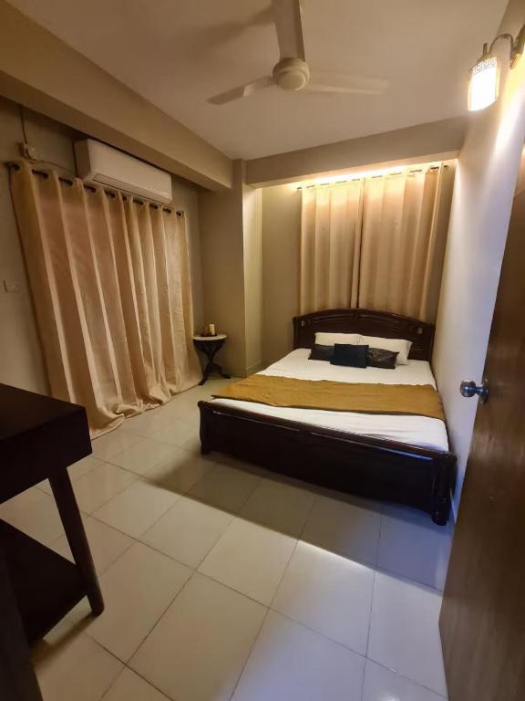 a bedroom with a bed in a room with a piano at Couple room, attached balcony in Safipur