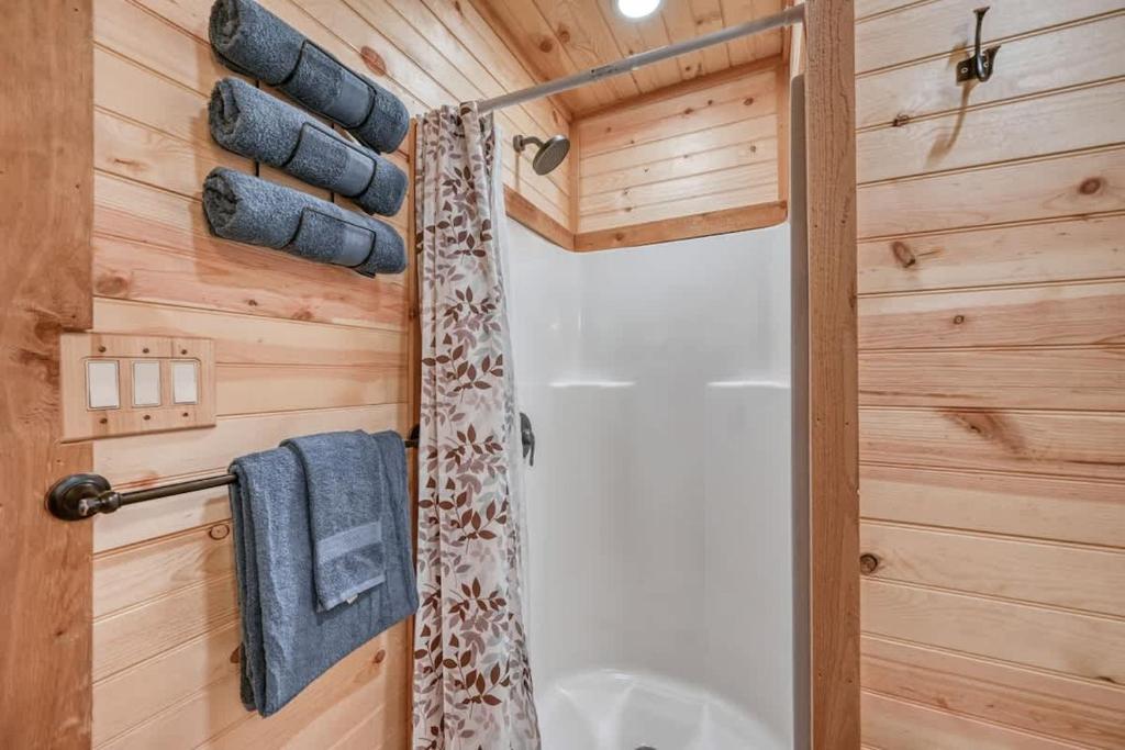 a bathroom with a shower and a shower curtain at Rustic Cabin with Firepit and Grill - 10 mins to Main St in Rocky Hill