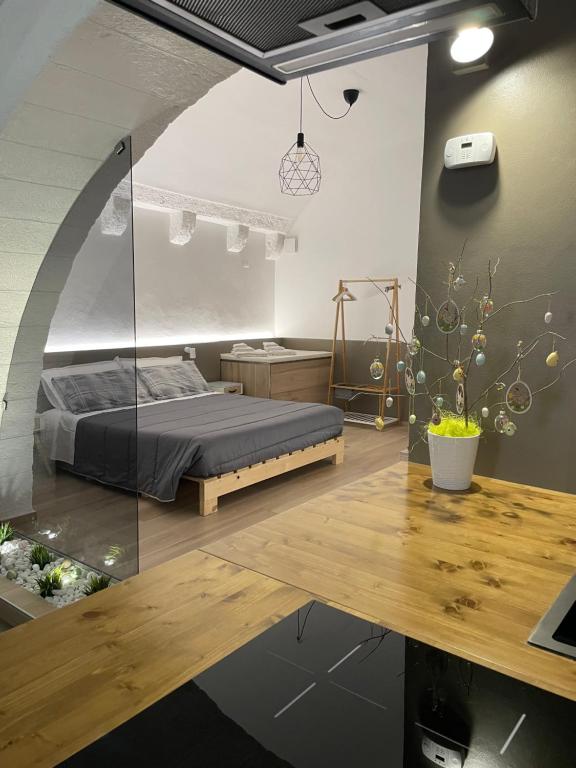 a bedroom with a bed and a wooden table at Archome Luxury Apartment in Brindisi