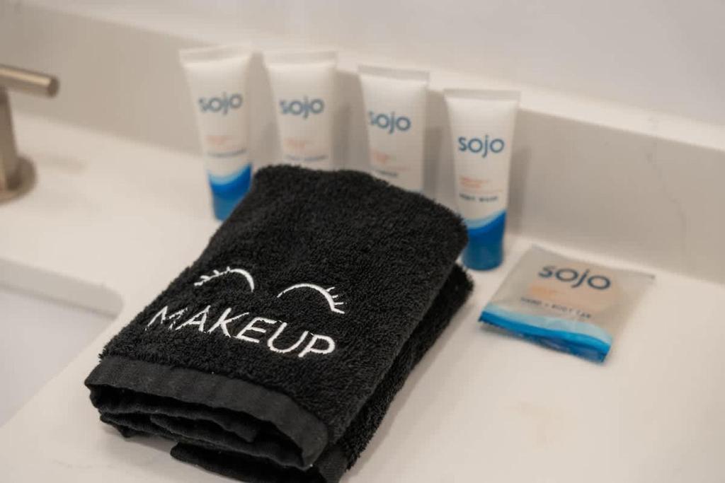 a black towel on a counter with a group of products at Rosé Retreat: Luxurious Getaway for 6, Hot Tub, Steps to Main Street in Fredericksburg