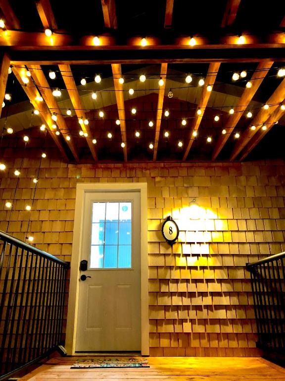 a room with a door and lights on a brick wall at 8 Clarence Ln in Cavendish