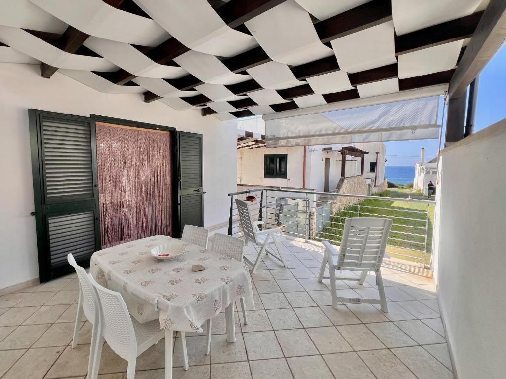 a dining room with a table and chairs on a balcony at Villetta Capilungo by Paf in tour in Capilungo