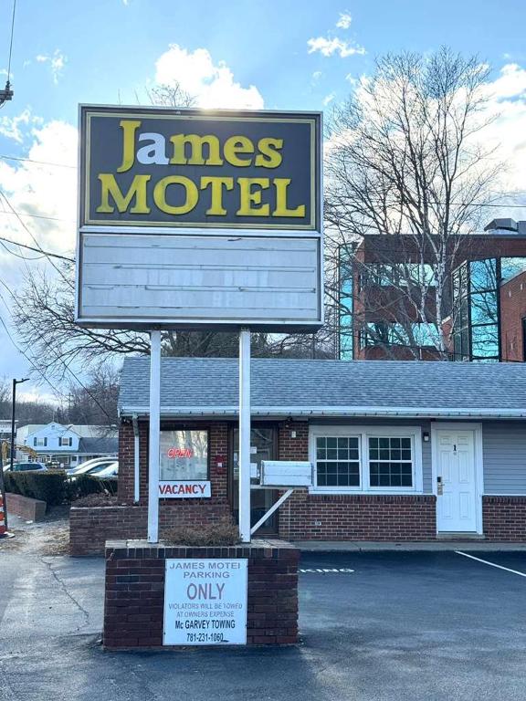 a sign for a mens motel in a parking lot at James Motel in Saugus