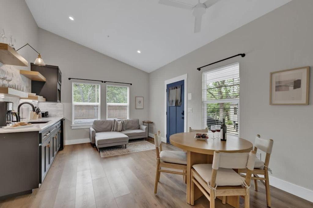 a kitchen and living room with a table and chairs at The Grove Combo in Fredericksburg